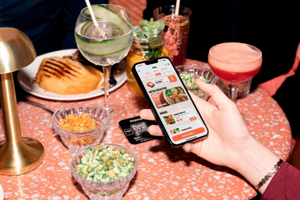 Restaurant customer, points-based loyalty program active on his phone