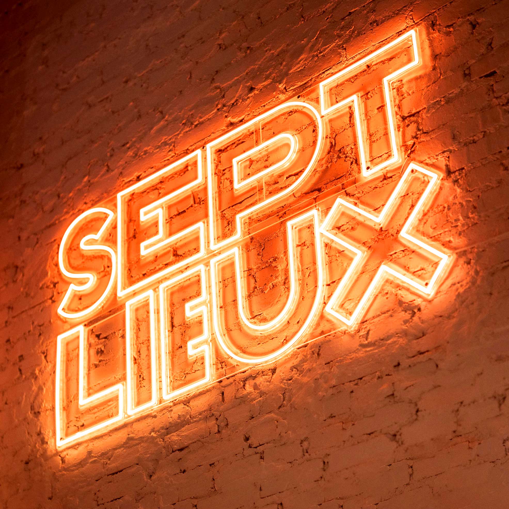 Orange neon sign for Sept Lieux food court